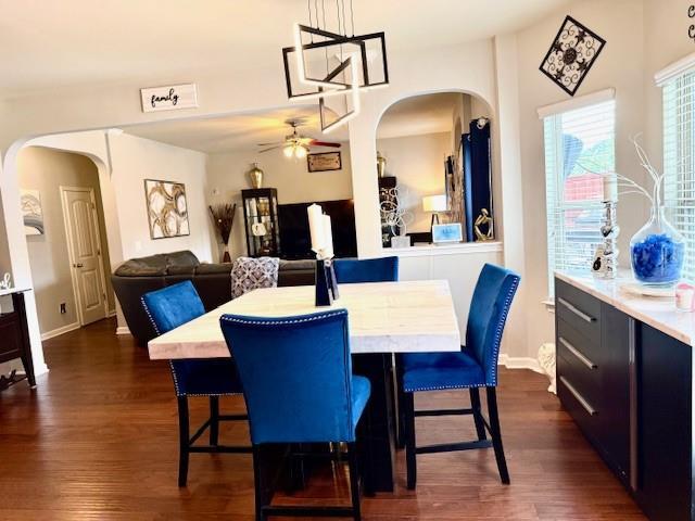 558 Hideaway Dr, Jonesboro, GA 30238 - dining space featuring dark wood-style flooring, a ceiling fan, and arched walkways