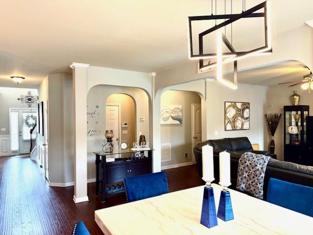 558 Hideaway Dr, Jonesboro, GA 30238 - dining space featuring arched walkways, ceiling fan, wood finished floors, and baseboards