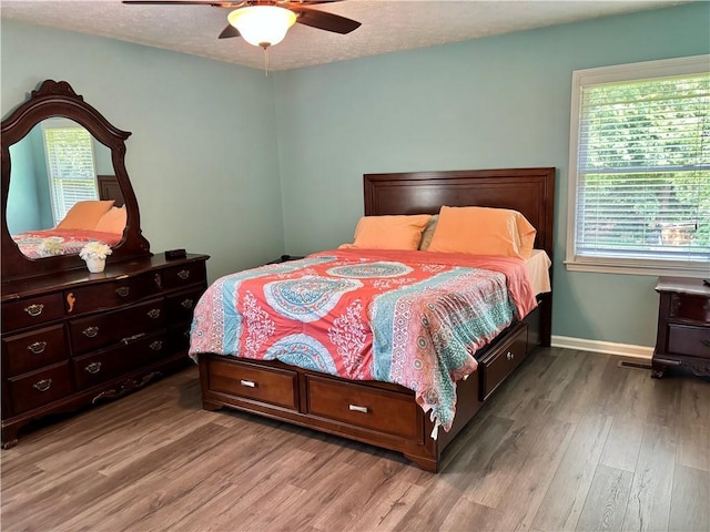 403 Hickory Walk, Woodstock, GA 30188 - bedroom featuring wood finished floors, baseboards, a ceiling fan, and a textured ceiling