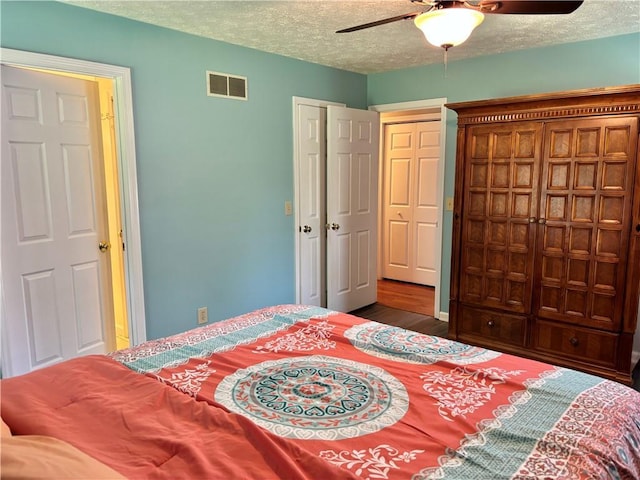 403 Hickory Walk, Woodstock, GA 30188 - bedroom featuring wood finished floors, a textured ceiling, and a ceiling fan