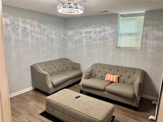 403 Hickory Walk, Woodstock, GA 30188 - living area with wood finished floors, baseboards, and a textured ceiling