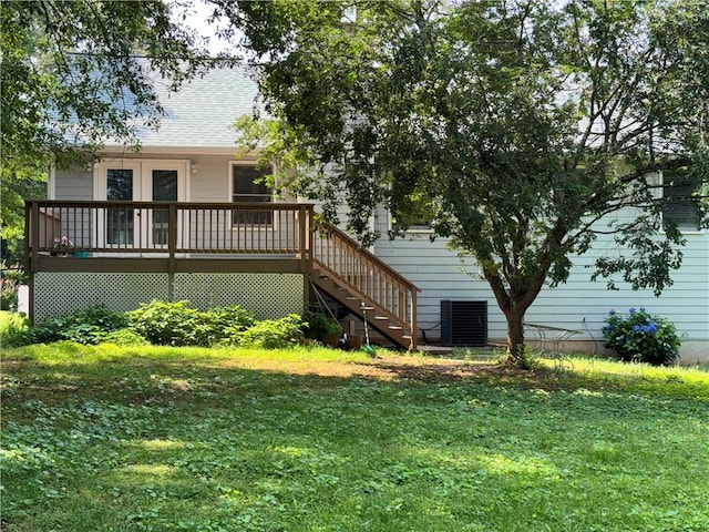 403 Hickory Walk, Woodstock, GA 30188 - back of property with a yard, a wooden deck, stairway, central AC unit, and roof with shingles