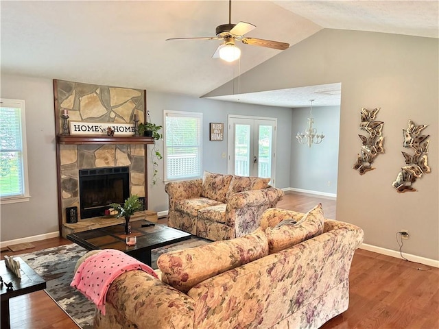 403 Hickory Walk, Woodstock, GA 30188 - living room featuring wood finished floors, plenty of natural light, a ceiling fan, a stone fireplace, and lofted ceiling