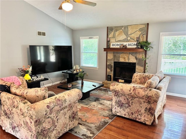 403 Hickory Walk, Woodstock, GA 30188 - living area featuring healthy amount of natural light, wood finished floors, vaulted ceiling, a stone fireplace, and baseboards