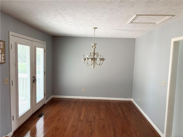 403 Hickory Walk, Woodstock, GA 30188 - unfurnished dining area with a textured ceiling, wood finished floors, baseboards, and a chandelier