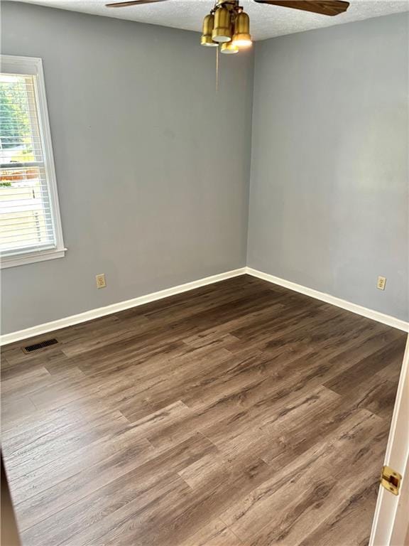 403 Hickory Walk, Woodstock, GA 30188 - empty room featuring a ceiling fan, dark wood finished floors, baseboards, and a textured ceiling