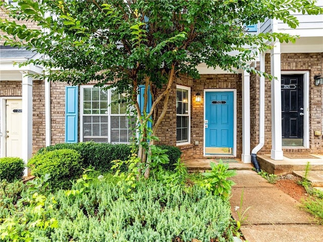 doorway to property with brick siding