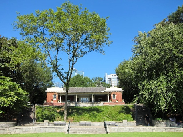 view of front of property with a front yard and brick siding