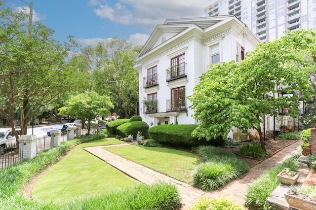 surrounding community with fence and a lawn