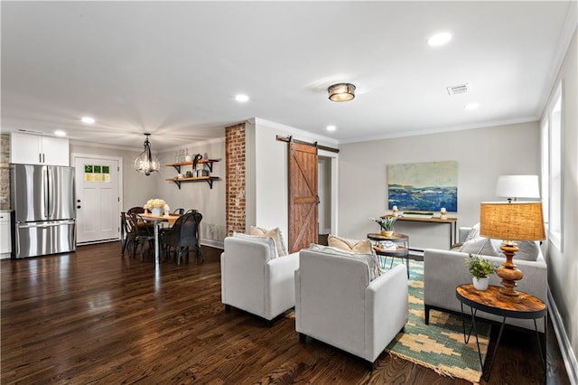 living room with a barn door, recessed lighting, dark wood-type flooring, visible vents, and crown molding