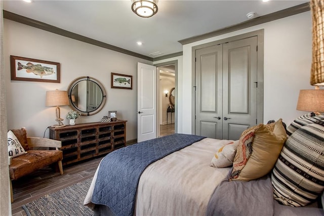 bedroom with crown molding and a closet