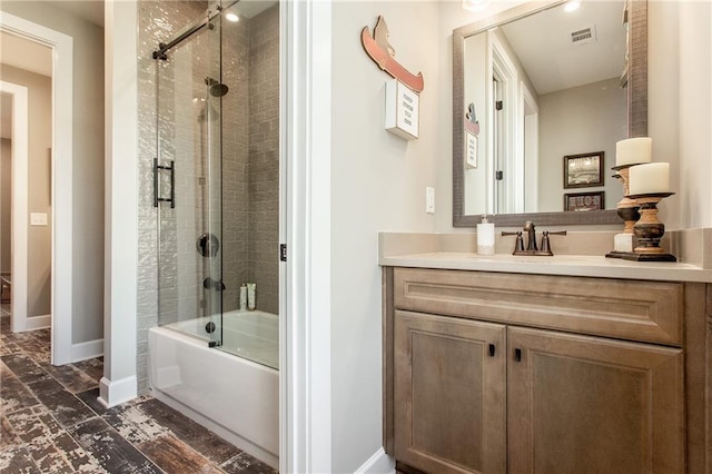 bathroom featuring shower / bath combination with glass door and vanity