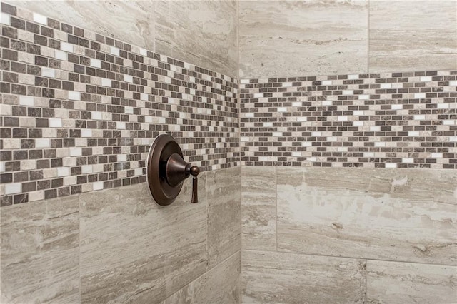 interior details featuring tiled shower