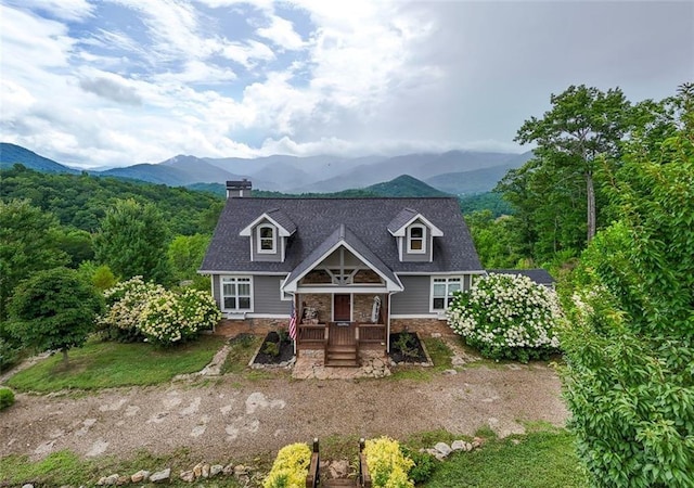 view of front of home featuring a porch and a mountain view