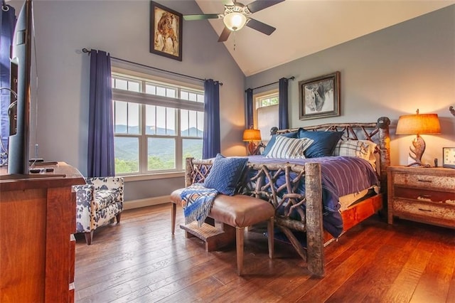 bedroom with hardwood / wood-style floors, multiple windows, vaulted ceiling, and ceiling fan