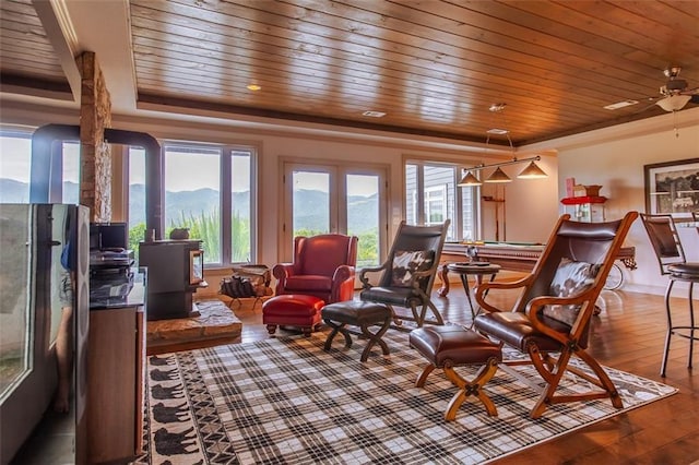 interior space featuring ceiling fan, a tray ceiling, hardwood / wood-style floors, and wooden ceiling