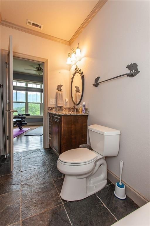 bathroom featuring crown molding, vanity, and toilet