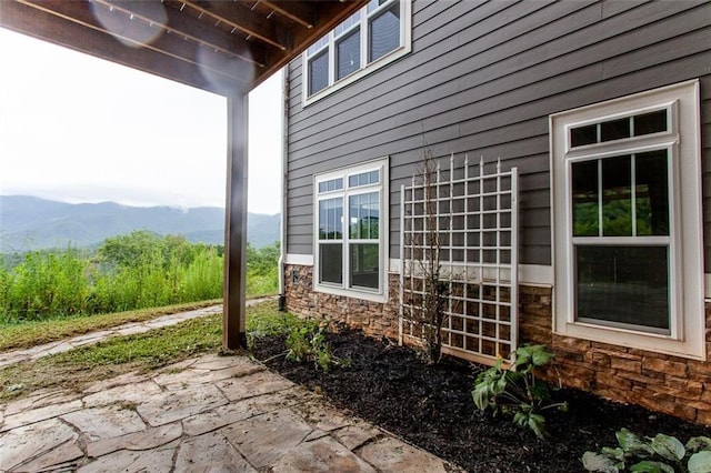 view of home's exterior featuring a mountain view and a patio area