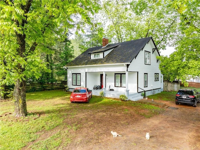 view of front facade with a porch and a chimney