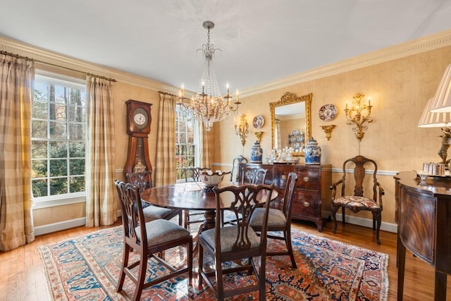 dining area featuring a notable chandelier, wood-type flooring, and ornamental molding