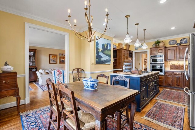 dining room featuring crown molding and light hardwood / wood-style floors