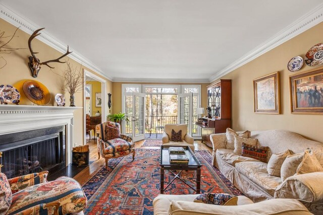 living room featuring ornamental molding and wood-type flooring