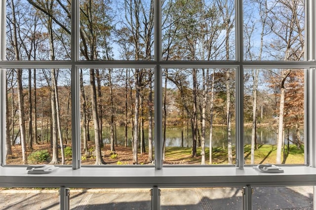 unfurnished sunroom featuring a water view