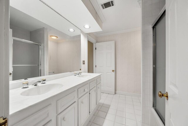 bathroom featuring enclosed tub / shower combo, ornamental molding, tile patterned flooring, and vanity