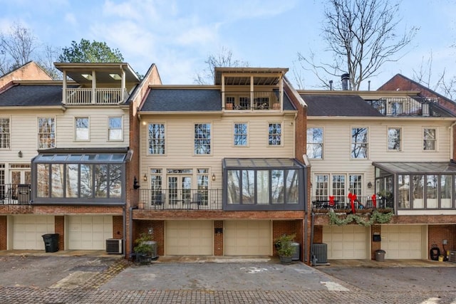 back of house featuring a garage and central air condition unit