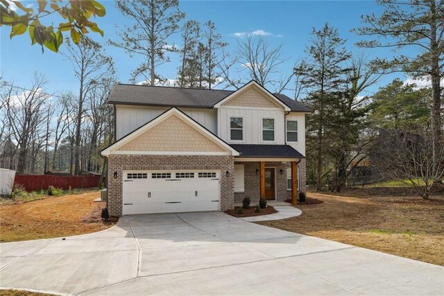 craftsman house with a garage, brick siding, driveway, and fence