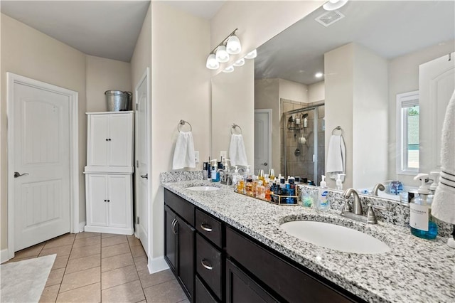 bathroom with vanity, tile patterned flooring, and a shower with door