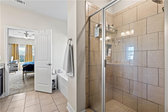 bathroom with vanity, ceiling fan, a shower with shower door, and tile patterned flooring