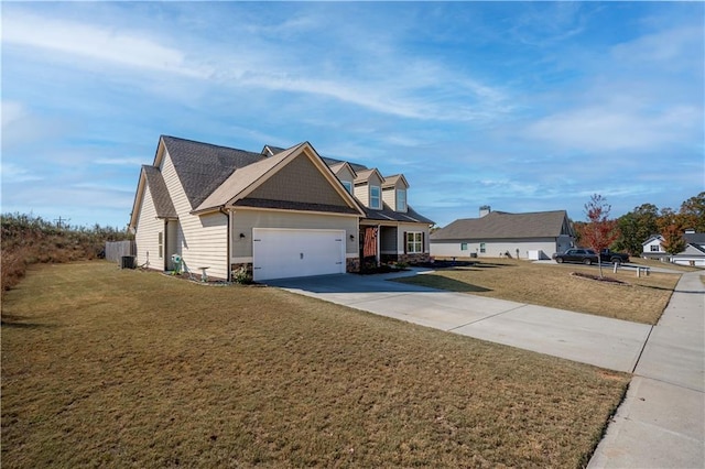 view of front of home with central air condition unit, a front lawn, and a garage