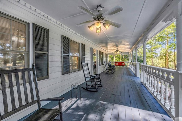 deck featuring covered porch and ceiling fan