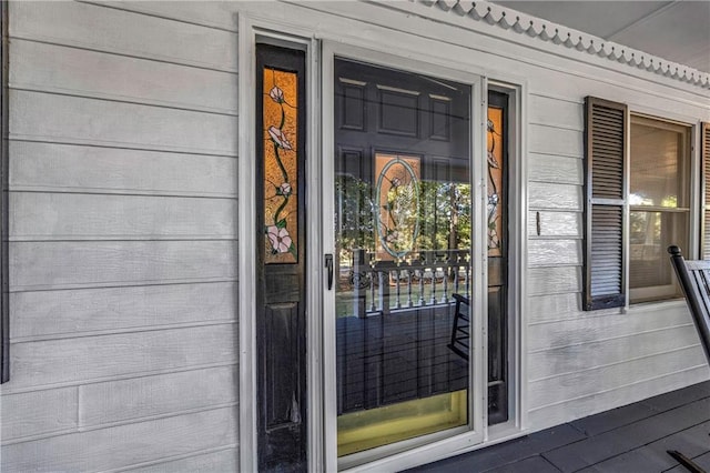 view of exterior entry featuring a porch