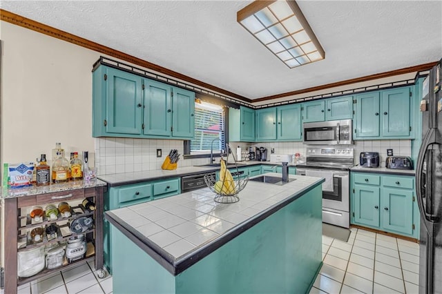 kitchen featuring appliances with stainless steel finishes, ornamental molding, a kitchen island with sink, and sink