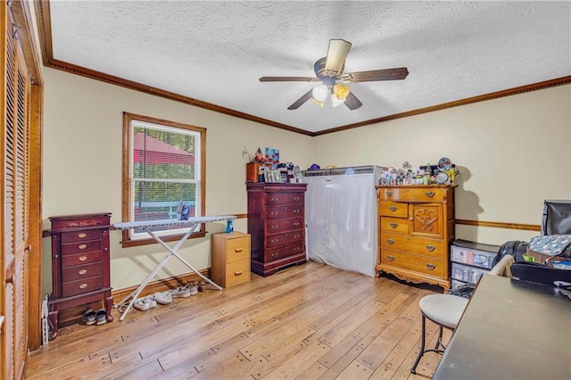 interior space featuring light wood-type flooring, crown molding, a textured ceiling, ceiling fan, and a closet