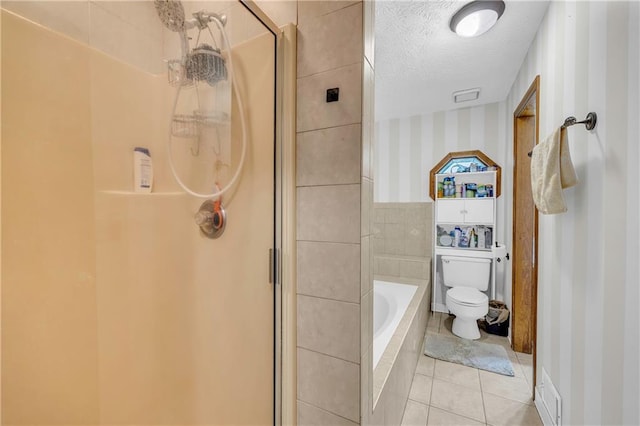 bathroom with a textured ceiling, toilet, independent shower and bath, and tile patterned floors