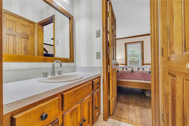 bathroom featuring crown molding, vanity, and tile patterned floors