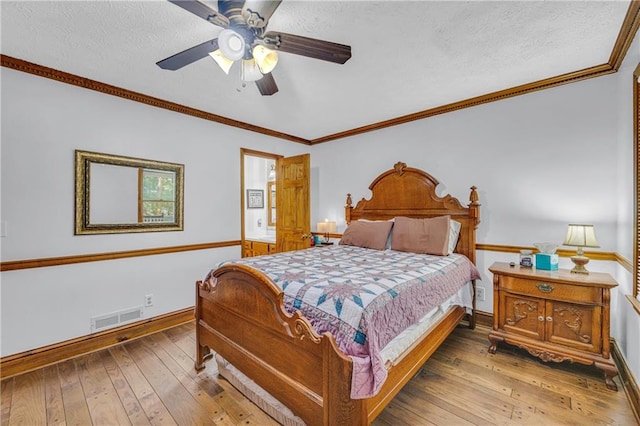 bedroom with wood-type flooring, a textured ceiling, and ceiling fan