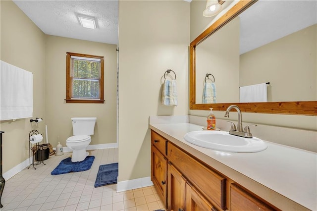 bathroom featuring vanity, toilet, tile patterned floors, and a textured ceiling