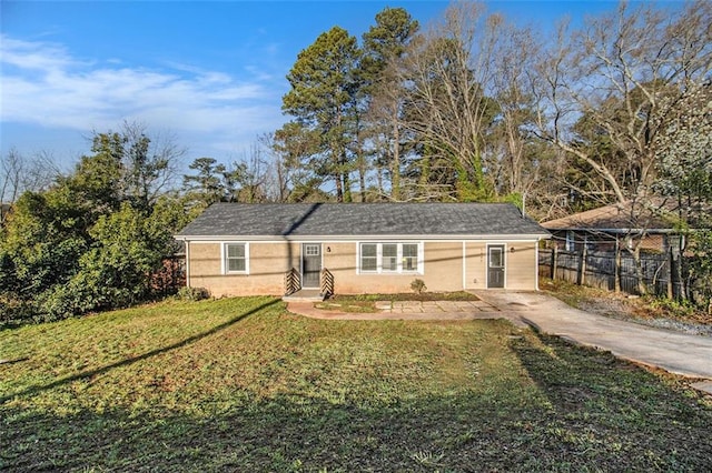 ranch-style house with stucco siding, a front yard, and fence