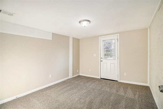 carpeted spare room featuring visible vents and baseboards