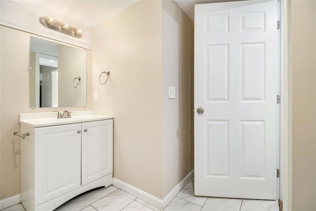 bathroom with vanity, baseboards, and marble finish floor