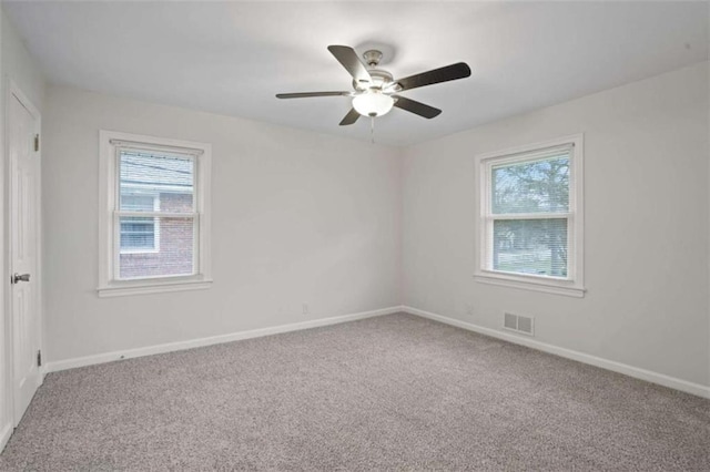 empty room with ceiling fan and carpet