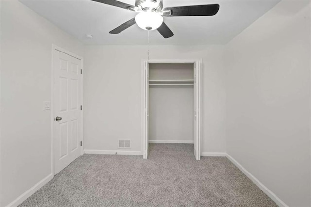 unfurnished bedroom featuring a closet, ceiling fan, and light colored carpet