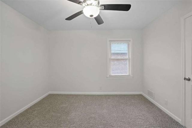 unfurnished room with ceiling fan and carpet flooring