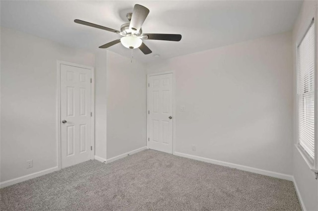 unfurnished bedroom with ceiling fan and carpet floors