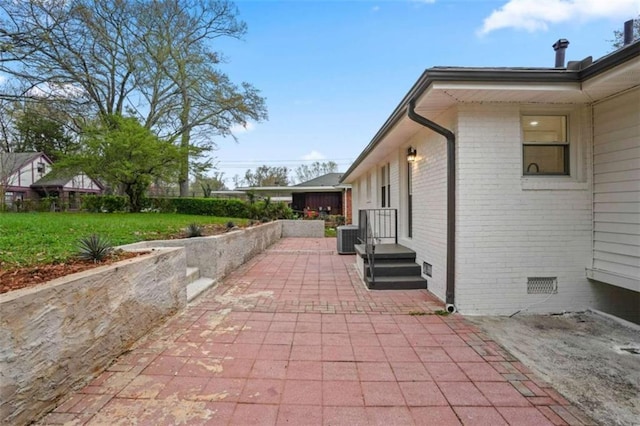 view of home's exterior with central air condition unit, a patio area, and a yard