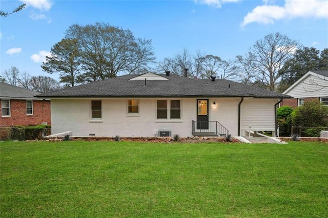 rear view of property featuring a yard